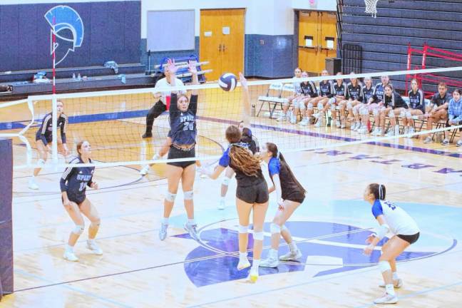 Sparta's Emma Kristiansen (24) leaps in anticipation of the ball crossing the net. She made two blocks.