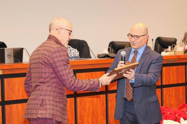 Deputy Mayor Dean Blumetti, right, presents a plaque to Mayor Neill Clark.