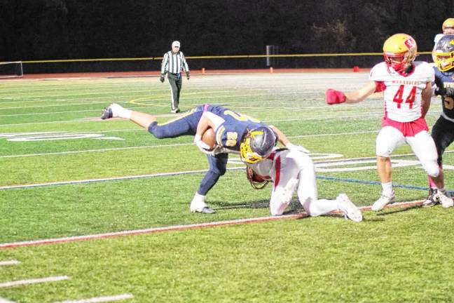 <b>Vernon tight end Luca Vizzini (20) tries to keep his balance after being hit by a Mount Olive defender.</b>