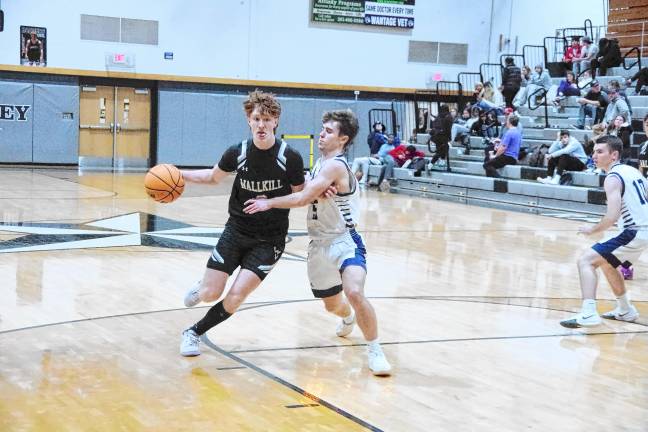 Wallkill Valley’s Ryan Geene handles the ball while covered by Sparta’s Hayden Kopco. Geene scored three points, grabbed seven rebounds and was credited with three steals.