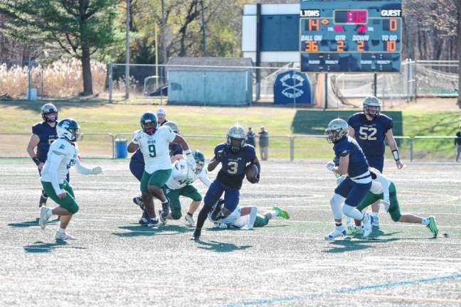 <b>Pope John running back Tylik Hill (3) carries the ball through an opening. Hill rushed for 210 yards and scored four touchdowns. (Photo by George Leroy Hunter)</b>