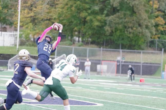 Pope John defensive back Nicholas Vannatta catches the ball, resulting in an interception in the first half of the game against Delbarton on Saturday, Oct. 7. The Lions lost, 30-6, at home.