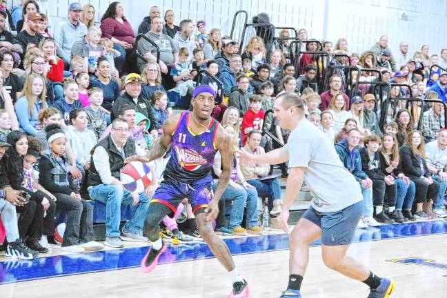 HW5 Harlem Wizards player Kamil ‘Dragon’ Brown dribbles the ball while covered by a Jefferson player.