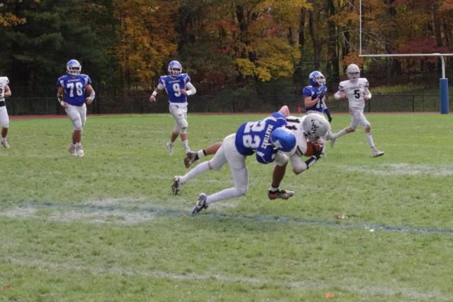 Kittatinny defender Niko Martinez (22) brings down Wallkill Valley receiver Jaden McNeil in the first half of their game Friday, Oct. 20. Kittatinny won, 27-7.