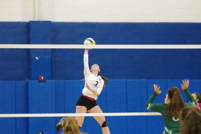Pope John's Madison Doherty reaches for the ball. Doherty contributed three aces, five service points, five kills, one block and ten digs. Photos by George Leroy Hunter