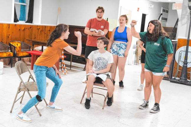 <b>Clockwise from left, Olivia Tomlin, Luke Simmons, Julia Kadar, Emily Gogick and Jay Granholm, center, rehearse the courtroom scene.</b>