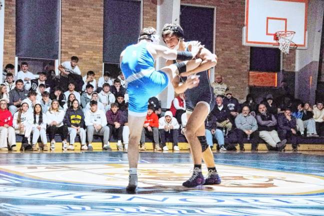 Pope John's Lukas Katsigiannis grips the leg of Sparta's Logan Hrenenko in the 150-pound match. Katsigiannis won by decision (10-6).