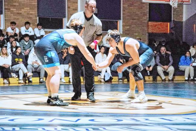 Sparta's Michael Pirrello, left, and Pope John's Shawn Baumann shake hands before the start of the 285-pound match. Baumann pinned Pirrello to earn the win.