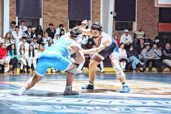 Pope John's David Thomson, right, grapples with Sparta's Sebastian Chiong in the 190-pound match. Thomson pinned Chiong to earn the win.