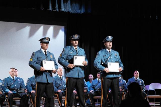 From left, Sgts. Rick Smith and Steve Guido and Officer Taylor May receive the Chief’s Commendation Award for their work on the Junior Police Academy.