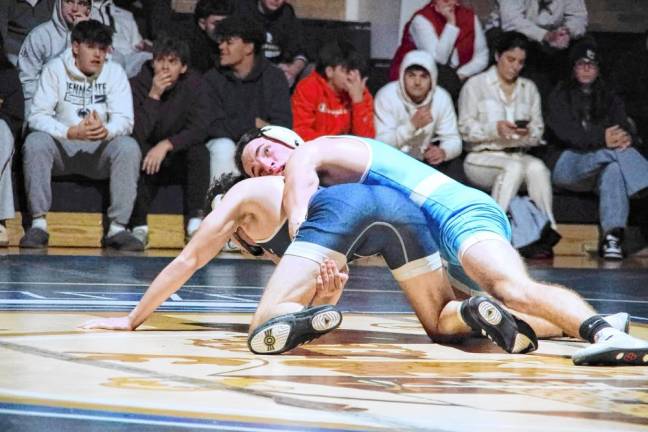 Sparta's Patrick Bruseo looks up at the time clock during his bout with Pope John's Frank Spagnola in the 126-pound match. Bruseo won by 'sudden victory' (14-11).