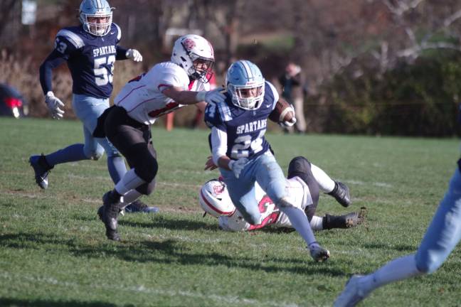 Sparta ball carrier Thomas Agudo on the run in the first half. Agudo rushed for 198 yards and scored one touchdown.