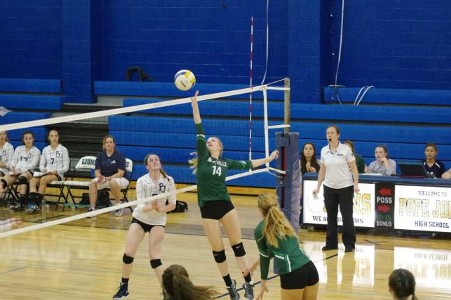 Montville's Maddie Morris (14) taps the ball towards the Pope John side of the net. Morris contributed five kills and three blocks.