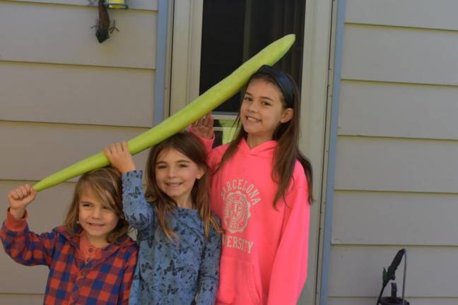 The kids with the season’s first cucuzza gourd, a strong contender for this year’s garden MVP. On Sept. 28, the zucchini were done, but the cucuzzi were still going strong.