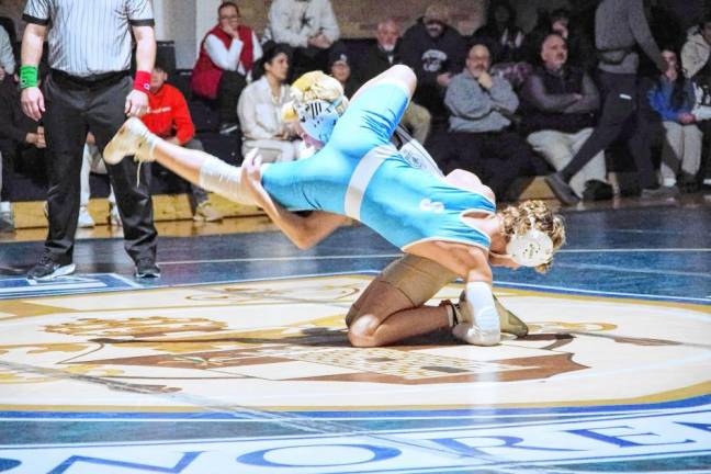 Pope John's Jake Holly upends Sparta's Johnathan Petelicki in the 113-pound match Jan. 9 at Pope John. Holly pinned Petelicki to earn the win. (Photos by George Leroy Hunter)