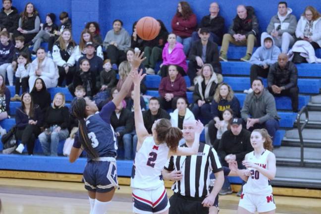 Pope John's Mia Washington (3) and West Morris Mendham's Halle Ferrara (2) reach for the ball during the tip-off to start the game.