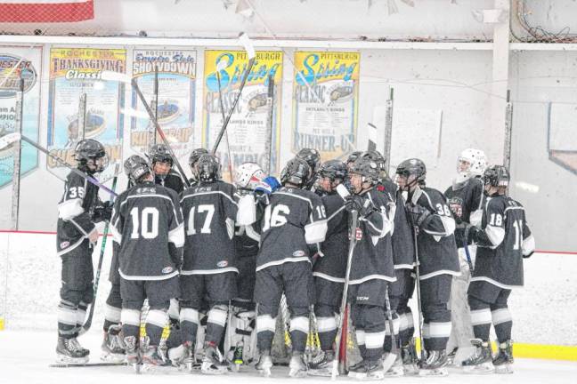 KJS United players gather in front of their goal post before the start of the game.