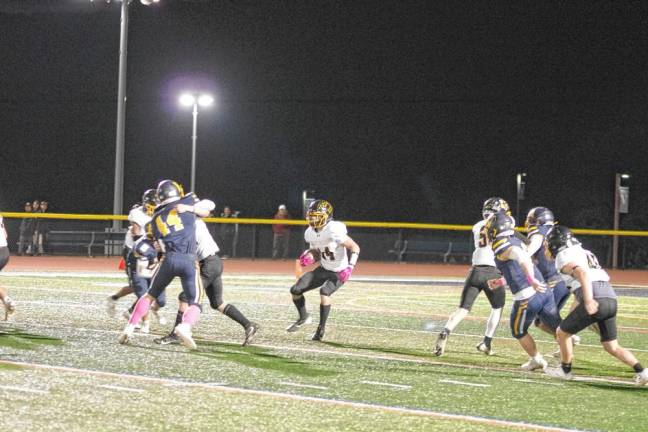 <b>West Milford ball carrier Patrick Foley moves toward an opening in the Vernon defense.</b>