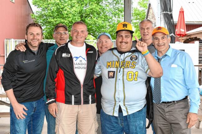 Brandon Bordt, second from right, poses with people who organized the Brandon’s House project, which raised $80,435 in cash donations and at least $25,000 in in-kind contributions of services.