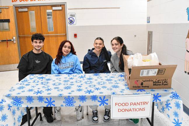 Jason Gutowski, Aliyah Beltran, Tamara Lelitka and Mia Boohoff collect donations for the food pantry.