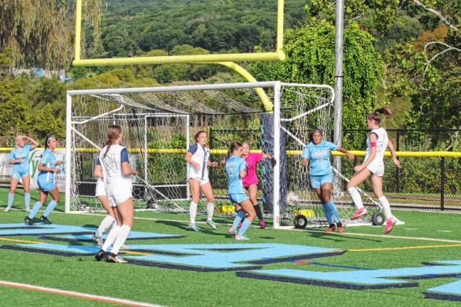 The Spartans and Cougars battle in front of the goal post.