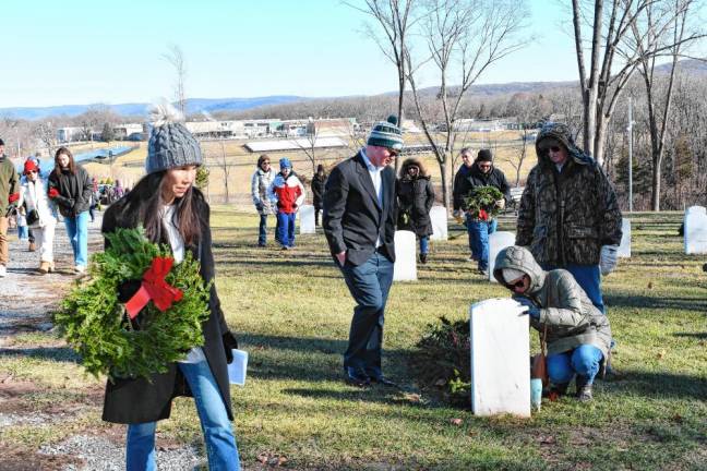 Volunteers place wreathes on graves Saturday, Dec. 14 at the Northern New Jersey Veterans Memorial Cemetery in Sparta. (Photo by Maria Kovic)