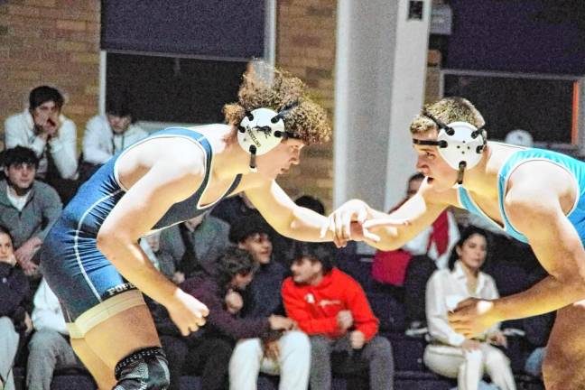 Pope John's Michael Morelli, left, and Sparta's Liam Hassloch reach for each other during the 215-pound match. Hassloch pinned Morelli to win.