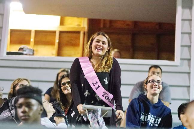 Hailey Enslin of Blairstown, New Jersey stands up as she is acknowleged on her 21st birthday. She is the younger sister of Sussex Stags quarterback Joe Enslin.