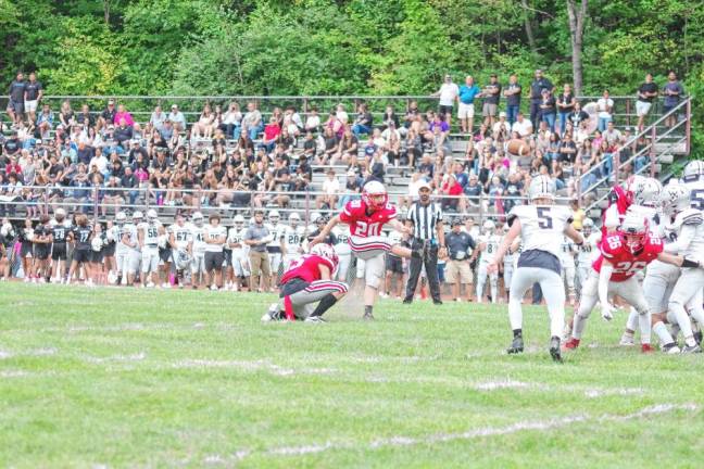 <b>High Point kicker Jacob Woods (20) kicks the ball during an extra point attempt in the first half. He made five extra-point kicks.</b>