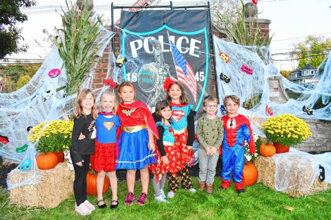 Costumed children pose at the Hanging with Heroes event at Veterans of Foreign Wars Post #7248 in Sparta.