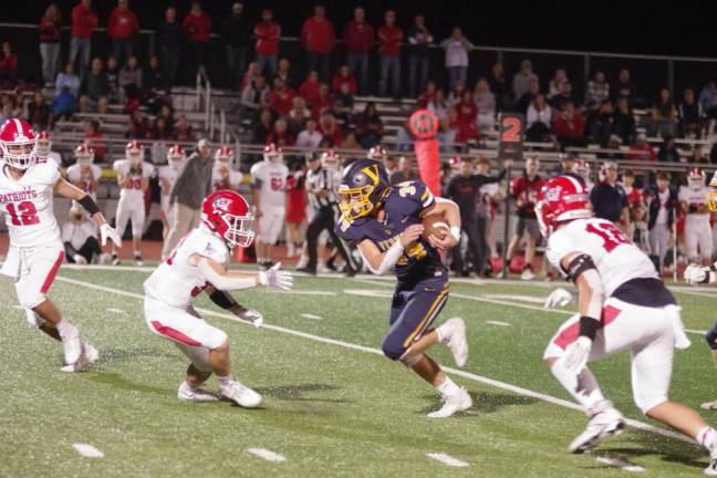 Vernon running back Logan Pych (34) moves the ball forward in the first half. Pych carried the ball 14 times and gained 112 yards.