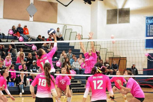 SV2 The Gaels and Spartans maneuver on the court. Both teams wear pink jerseys for Breast Cancer Awareness Month.