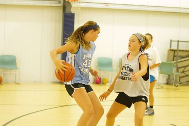 On Thursday, July 27, Brynn McCurry handles the ball while covered by Tayler Soules during basketball camp.