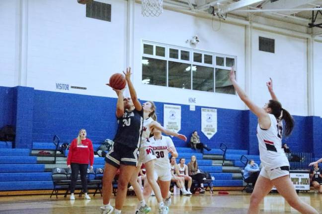 Pope John's Cailey Fitzmorris (30) takes a shot under tight coverage. She scored three points and grabbed five rebounds.