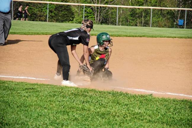 ST2 Wallkill Valley third base player Makayla Mehmedi tries to tag out a sliding Sussex Tech runner late in the game.