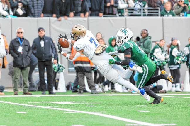 Pope John’s Nick Struble makes the catch for the longest pass play of the day for the Lions. DePaul’s Ryhen Thomas is defending.