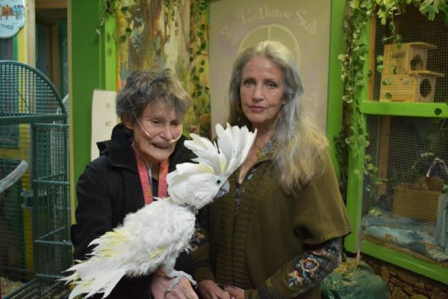 Rebecca Vives and Diana McGowan with Cinco, an umbrella cockatoo that came to the santuary from a neglectful situation.