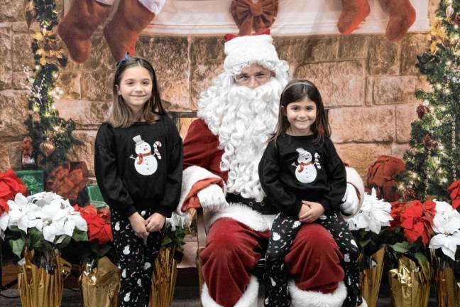 The Guarnari sisters pose with Santa.