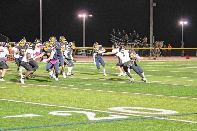 <b>Vernon wideout Gavin Bruno (22) is grabbed by a West Milford defender. </b>