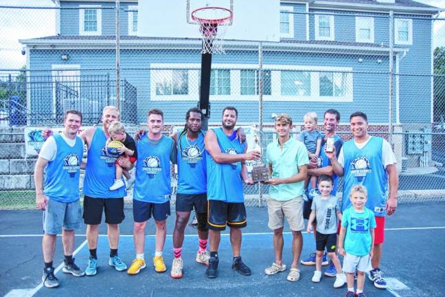 SB4 John Smalley, captain of Team Smalley, receives the championship trophy from Sussex County Commissioner Jack DeGroot after the team wins the Sparta Summer Basketball League Championship game July 31.