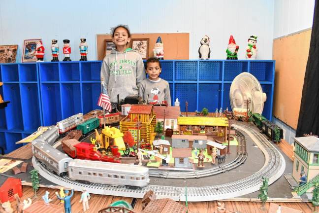 Madi and Jared Hackett of Clifton watch a model train move around the track.