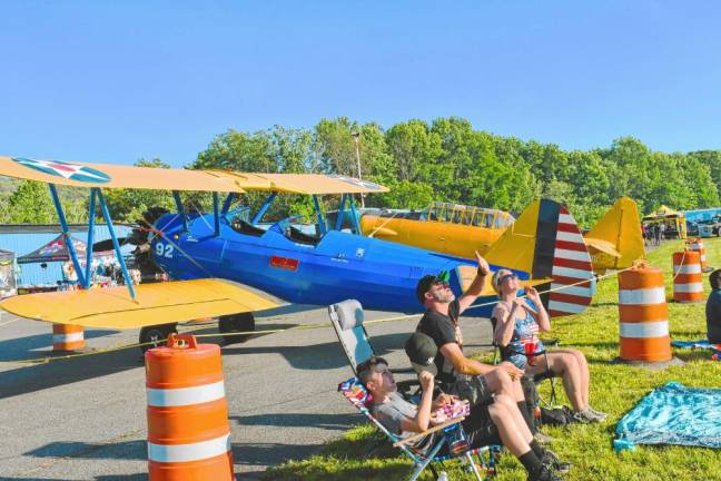 AIR2 People look up at the planes above Greenwood Lake Airport in West Milford. (Photo by Maria Kovic)