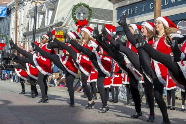 Students at the D’Marge Dance Studio in Newton do a kick line during the parade on Spring Street.