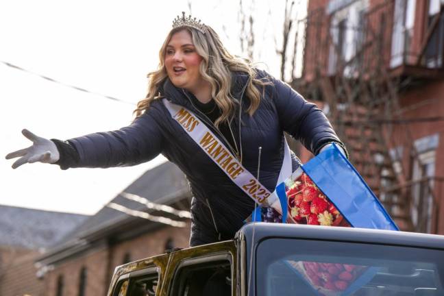 Miss Wantage Mackenzie Brooke Baker tosses candy to the crowd.