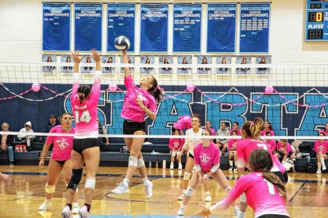 Sparta's Sylvia Przydzial gets a hand on the ball above the net.