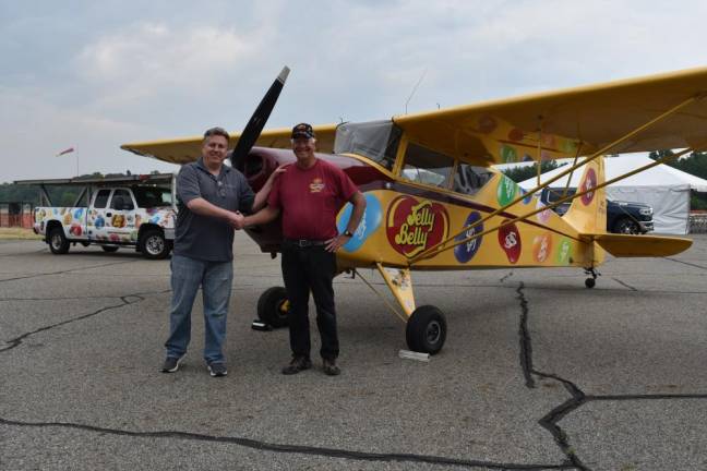 Tim Wagner, left, Greenwood Lake Air Show chairman, shakes hands with Kent Pietsch, who is making his debut performance at the 2023 event. They are standing by Pietsch’s 1940 vintage 800-pound interstate Cadet aircraft in which he performs his renown aerobatic routines. (Photos by Rich Adamonis)