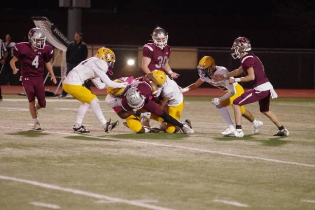 Lyndhurst defenders bring down a Newton ball carrier in the first quarter.