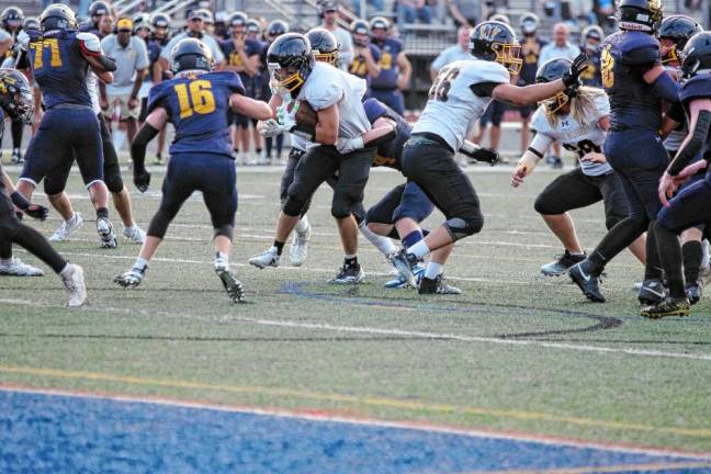 <b>A West Milford ball carrier is grabbed while trying to break through the Jefferson defense.</b>