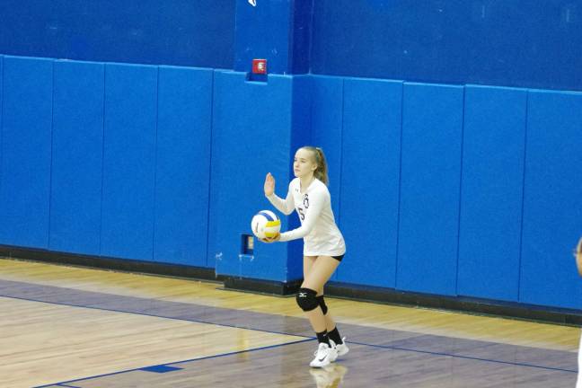 Pope John's Jackie Taylor about to serve. Taylor contributed two service points, three kills, one assist and six digs.