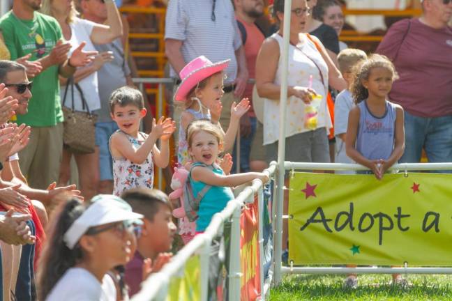 <b>Kids cheer and clap for K9s in flight at the fair.</b>